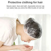 A person is using a clear disposable shower cap to cover their hair while in a bathroom setting.