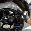 A hand applies a black tire refurbish coating to a tire rim in a car context.