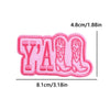 Pink embroidered patch spelling out YAML with boots on a pink fabric background