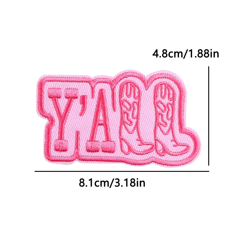 Pink embroidered patch spelling out YAML with boots on a pink fabric background