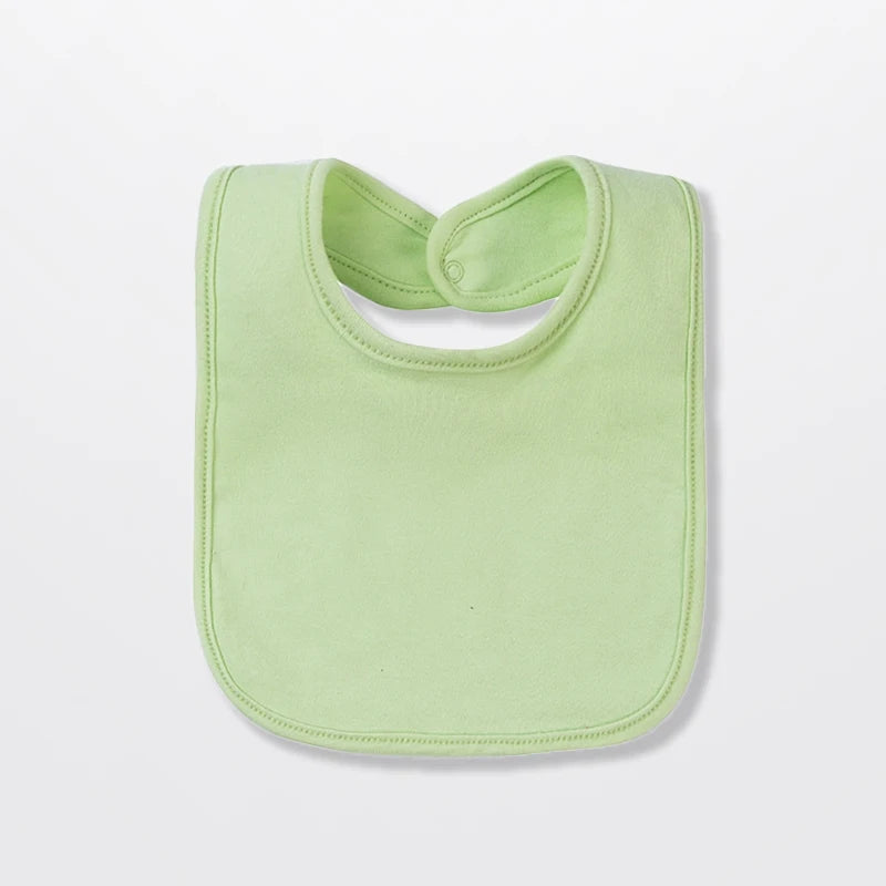 A light green cotton bandana bib for a baby, shown from the top view.