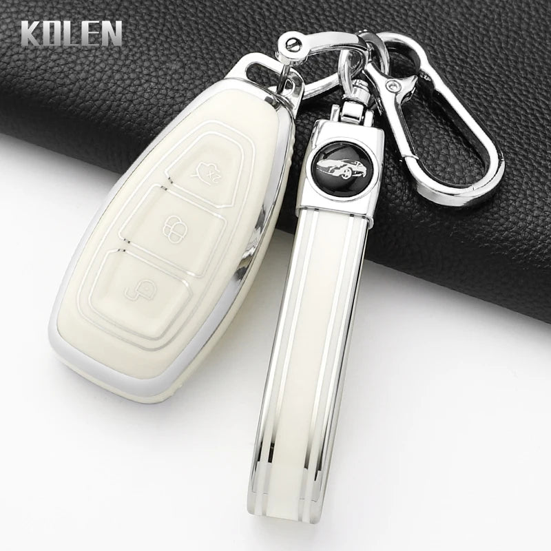 Silver silicone car key fob cover with a black emblem attached to a metal keyring.