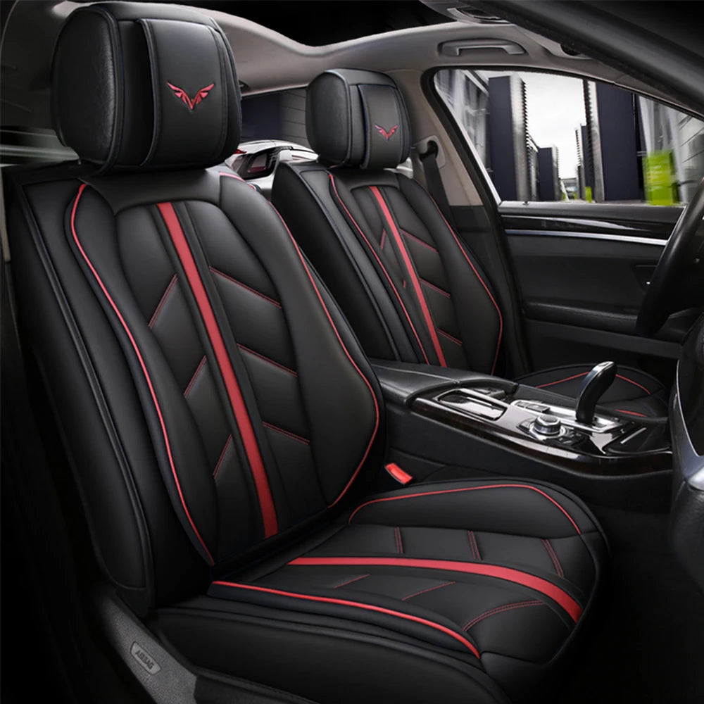 Black car seat covers with red stitching and accents installed in a vehicle interior.