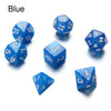 A set of matte black polyhedral dice, including a blue d10 and d6.