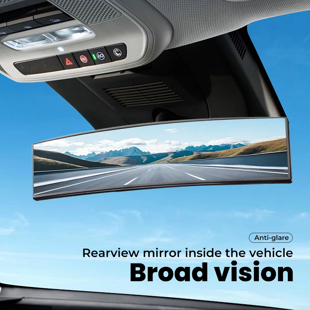 A rear view mirror inside a vehicle showing a broad vision of the road and surrounding landscape.