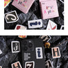 A collection of vintage alphabet stickers in various colors and shapes scattered on a dark surface.