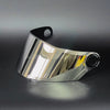 A shiny silver replacement motorcycle helmet visor is shown in a profile view against a dark background.