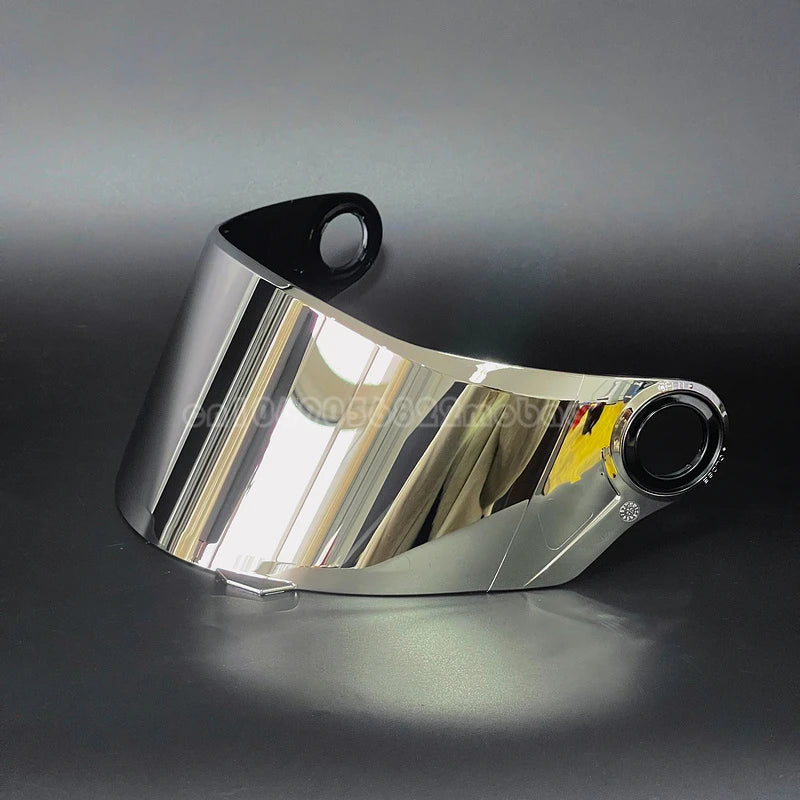 A shiny silver replacement motorcycle helmet visor is shown in a profile view against a dark background.