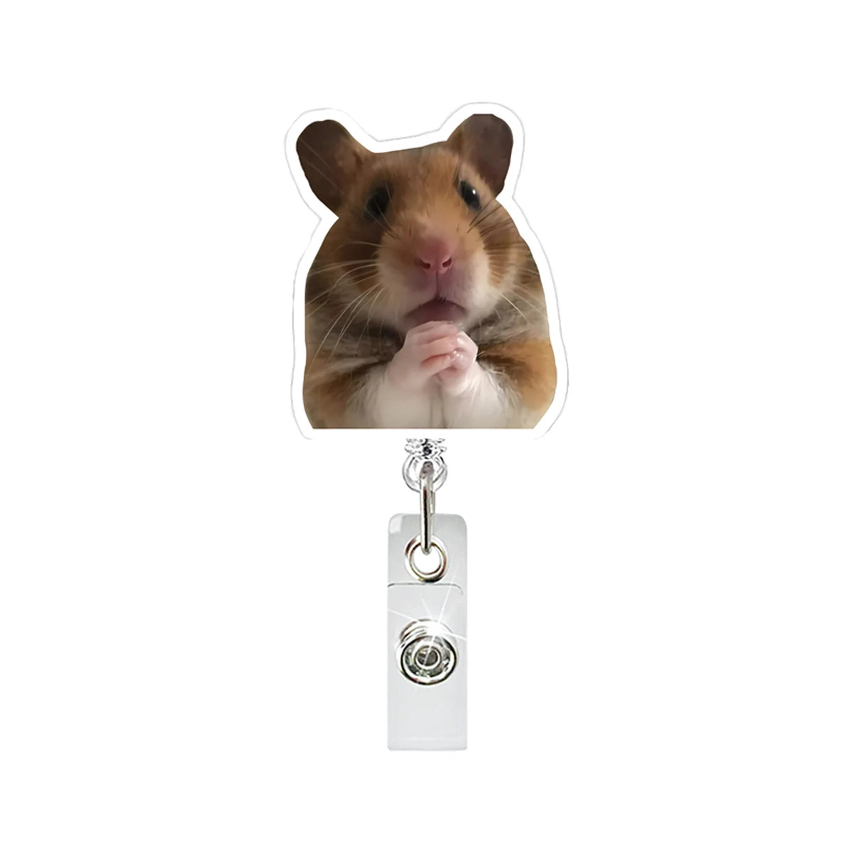 A brown hamster is pictured next to a silver badge reel with an alligator clip.