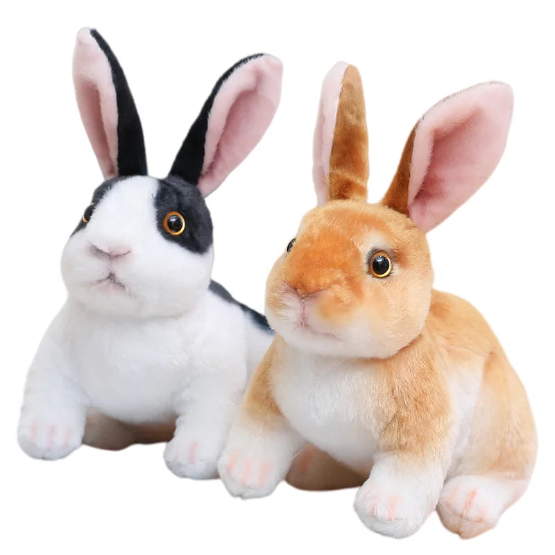 A plush rabbit stuffed animal with white and black markings and a fluffy orange colored rabbit.