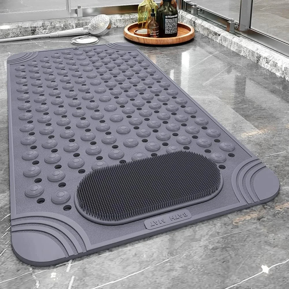 A gray non-slip bath mat featuring massage nodes and suction cups placed on a marble countertop.