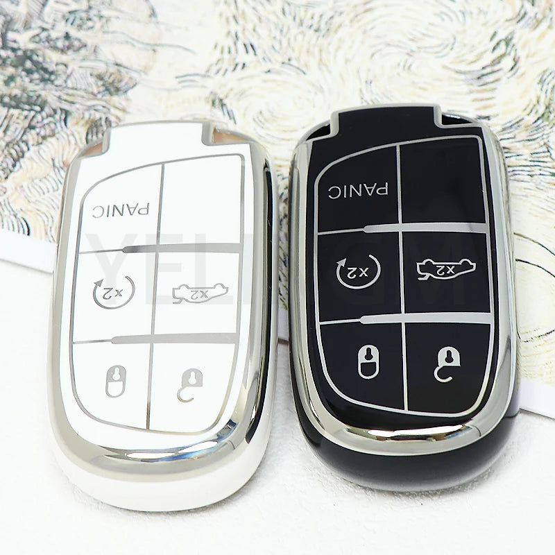 A pair of black and silver car key fobs displayed on a white background.