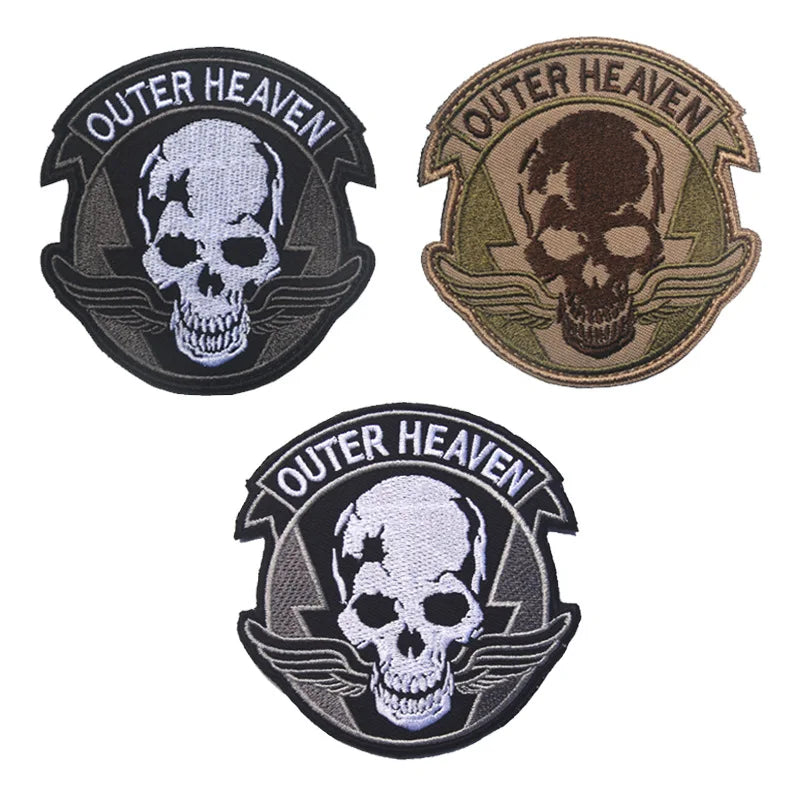 Three embroidered patches featuring a skull design with the text Outer Heaven on a dark background.