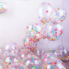 Clear balloons filled with pink and purple confetti shreds for parties and celebrations