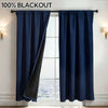 A dark blue blackout curtain panel hanging in a window frame.