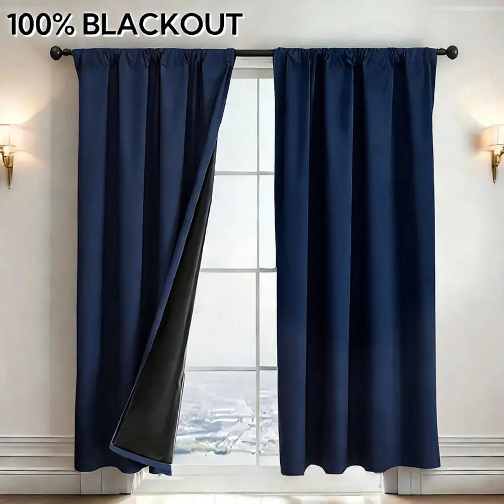 A dark blue blackout curtain panel hanging in a window frame.