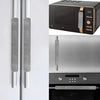 Two silver oil-proof refrigerator handle covers mounted on a white cabinet door.