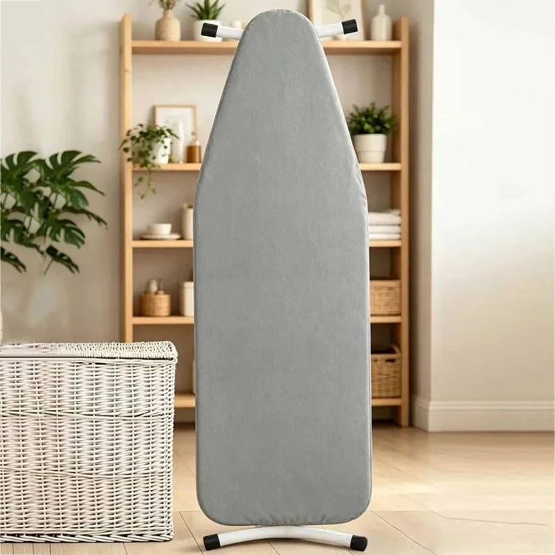 A gray ironing board cover with heat reflective padding standing on a white base.