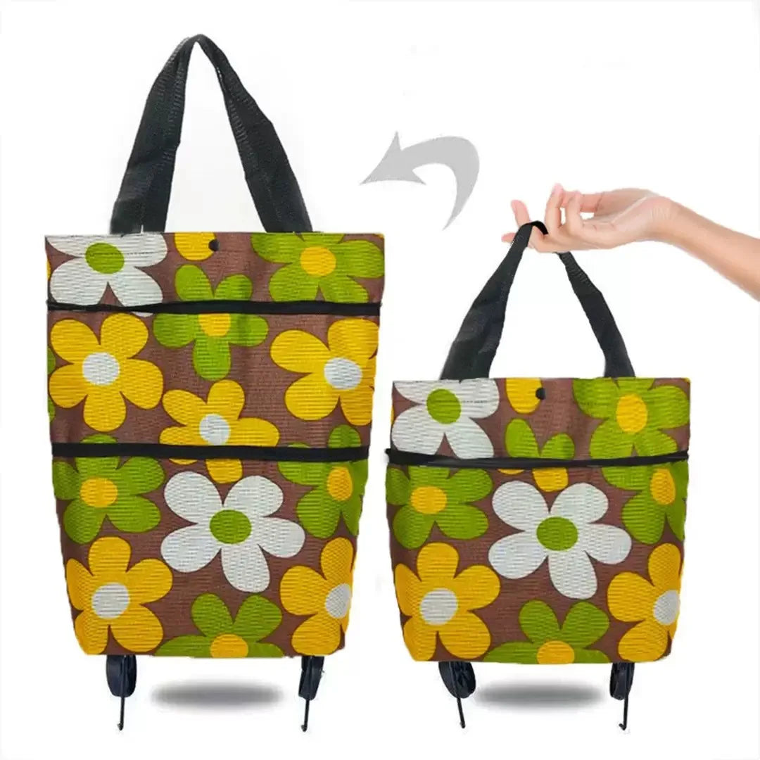 A foldable rolling shopping bag in brown and yellow floral pattern with black handles and wheels.
