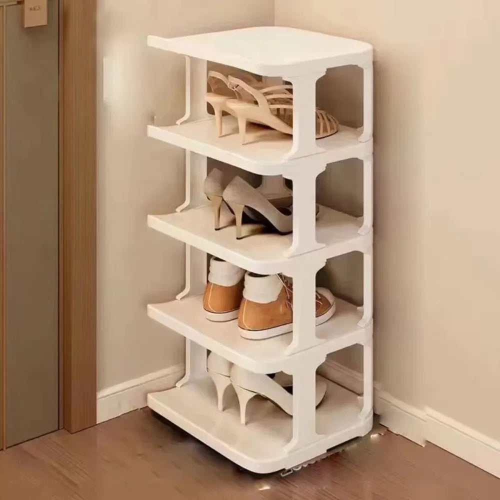 A white stackable vertical shoe rack with multiple tiers holding various pairs of shoes.