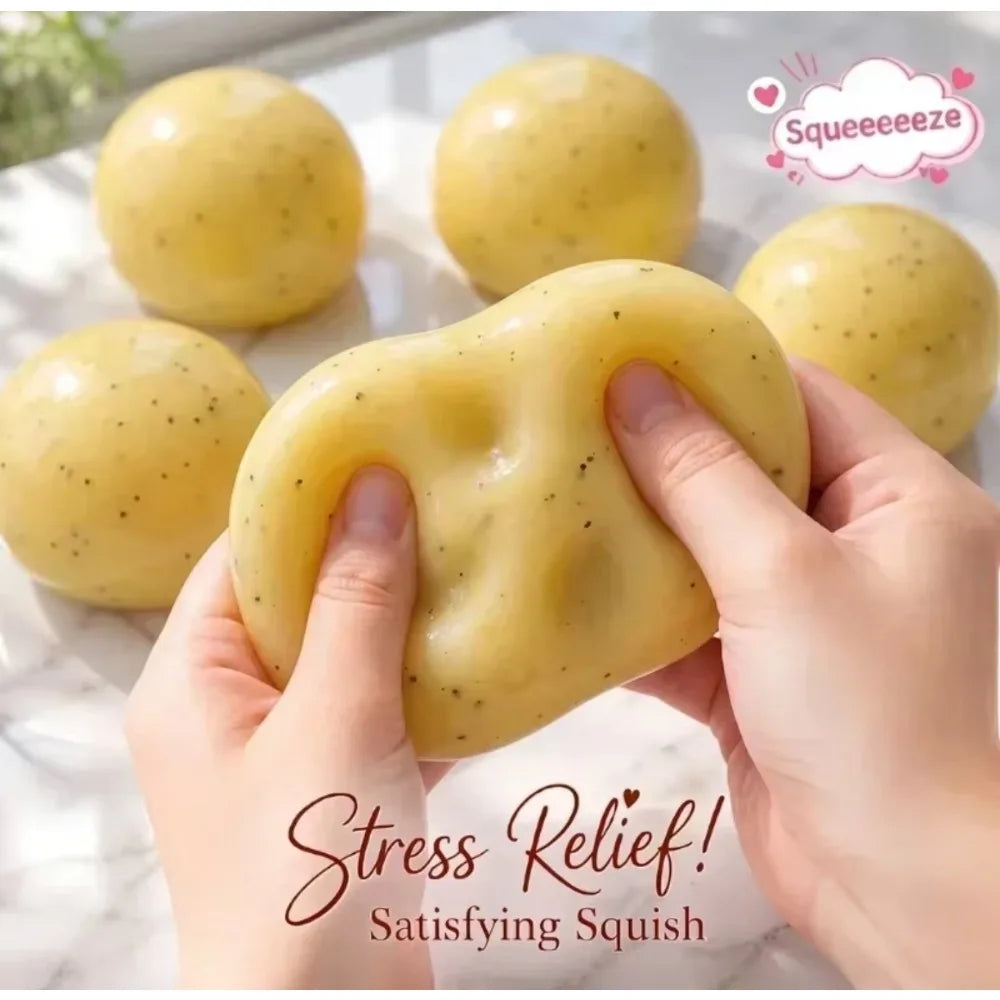 Hands squeezing a yellow potato slushie squishy toy with other similar toys in the background.