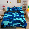A blue and teal camouflage duvet cover set displayed on a bed with white nightstands and wooden shelving.