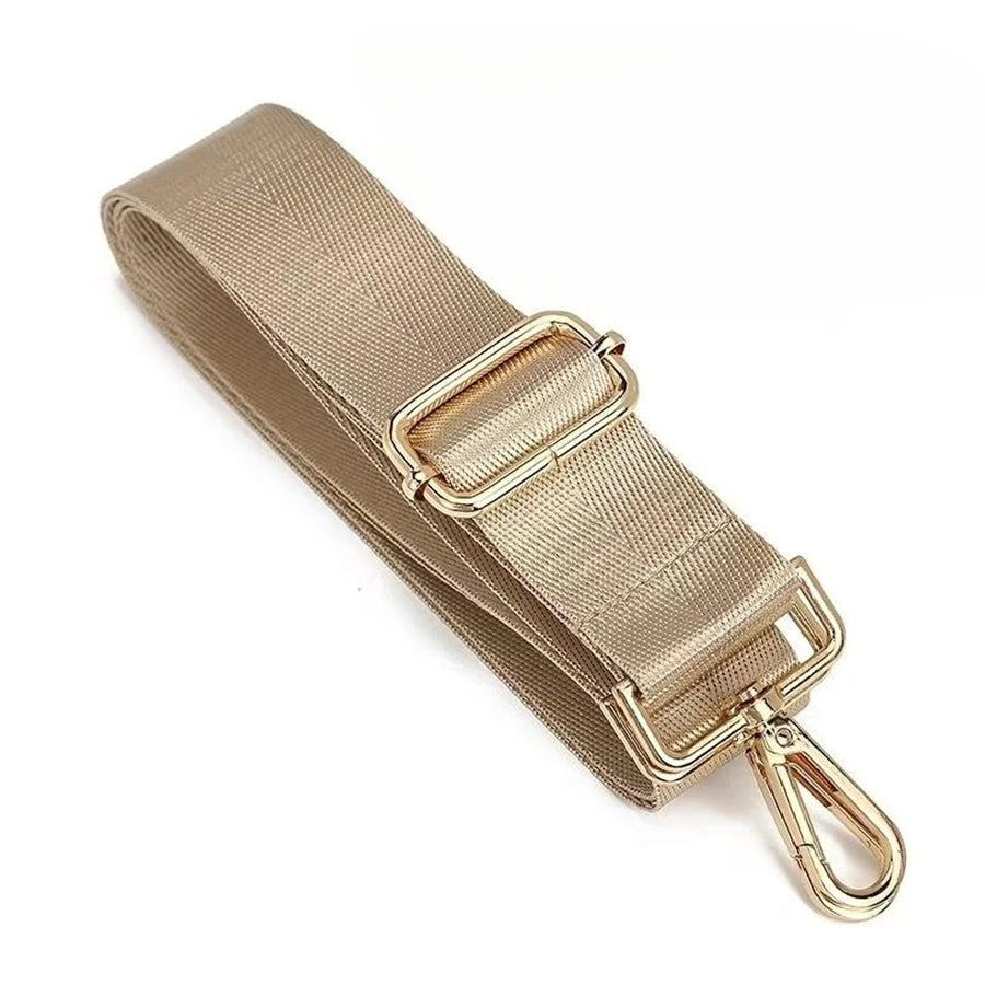 A beige nylon bag strap with a gold buckle shown diagonally.