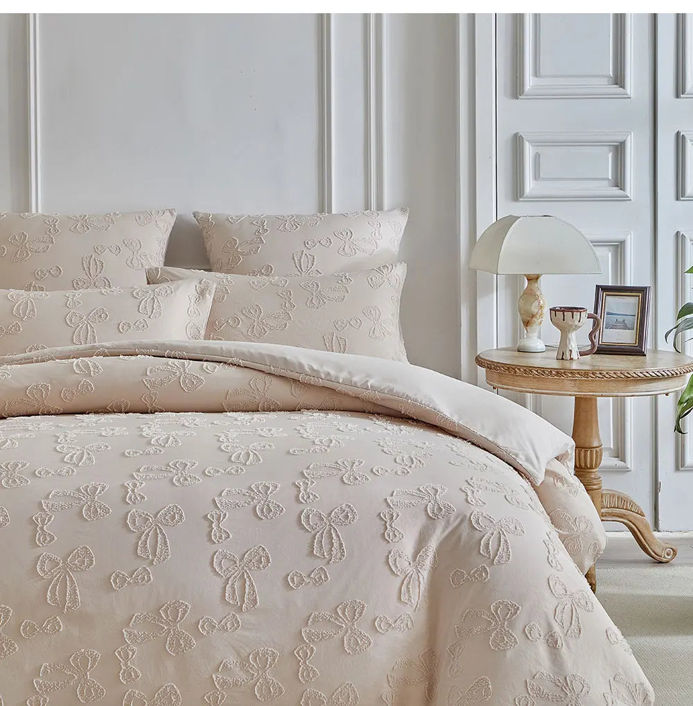 A beige Nordic leaf print duvet cover set displayed on a bed with white molding and a bedside table.