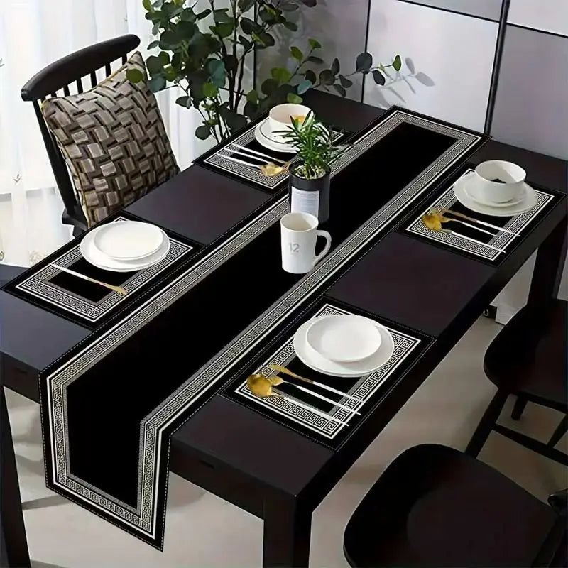 A set of black and silver geometric placemats and table runners for dining.