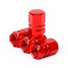 A shiny red aluminum alloy tire valve cap with a hexagonal shape.