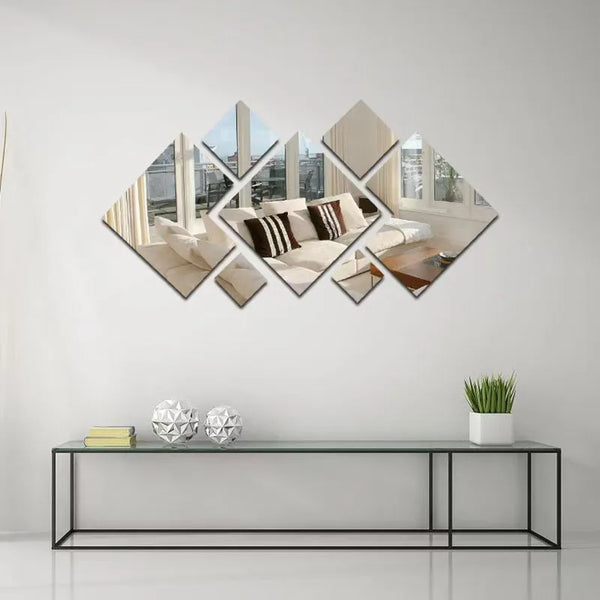 A decorative wall art piece featuring a geometric arrangement of acrylic mirrors and framed photos on a white wall.