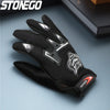 A close-up of black full finger nylon riding gloves with anti-slip grips resting on a gray surface.