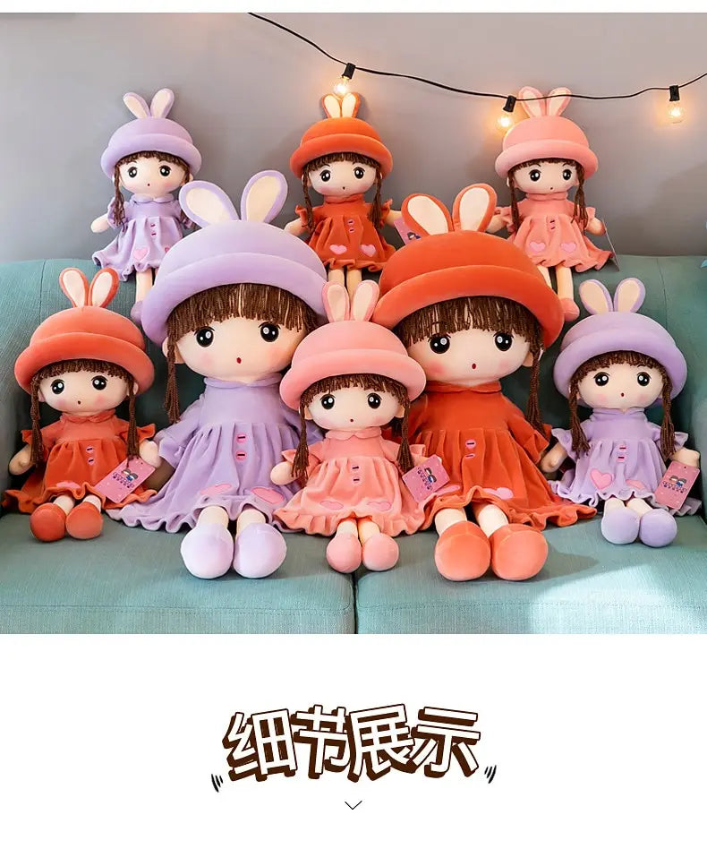 A collection of nine soft and cuddly plush dolls dressed as rabbits in various colors including pink purple orange and peach.