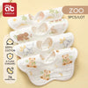 A set of five white soft cotton muslin bandana bibs for babies with cute animal designs