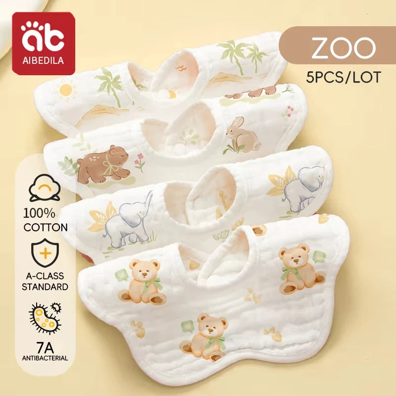 A set of five white soft cotton muslin bandana bibs for babies with cute animal designs