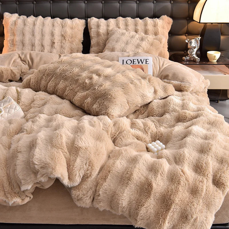 A beige faux fur bedding set featuring a duvet and pillows on a bed.