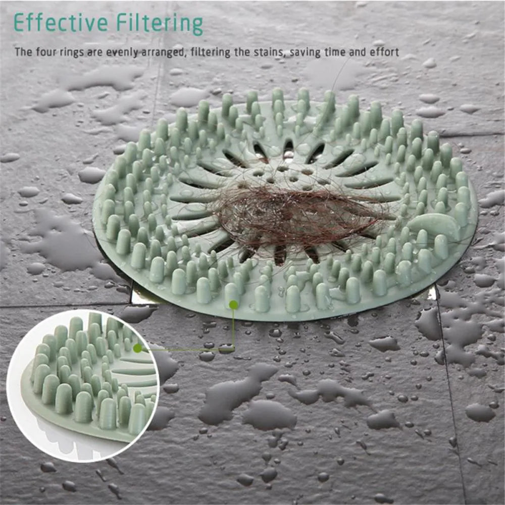 A close-up view of a green silicone drain hair catcher with four evenly-arranged rings filtering stains from water droplets.