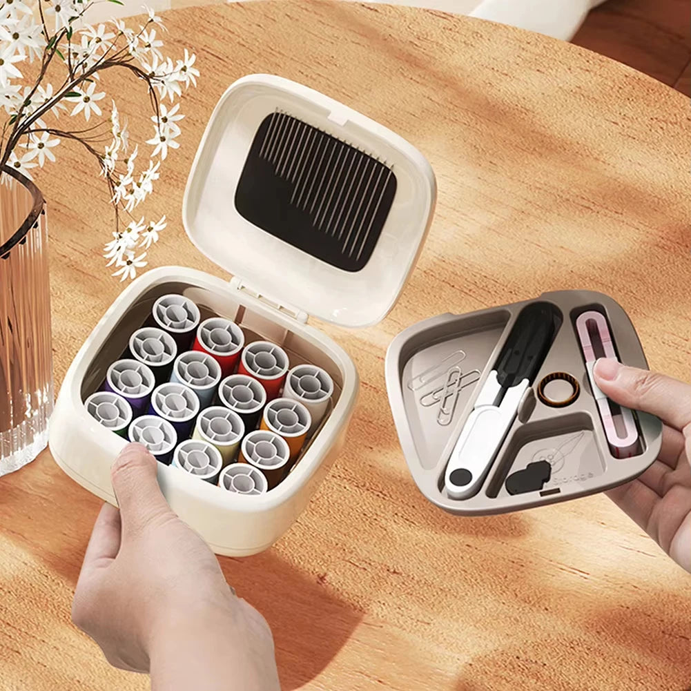 A hand opens a compact magnetic sewing kit containing 20 needles and various thread colors on a wooden table.