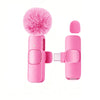 A pink USB-C wireless lavalier microphone with a fluffy pink foam windscreen and a rectangular body.