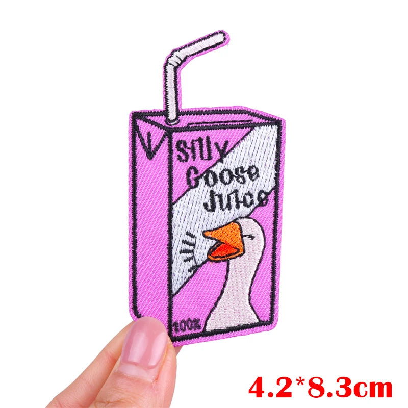 Pink embroidered iron-on patch featuring a cartoon goose face and text