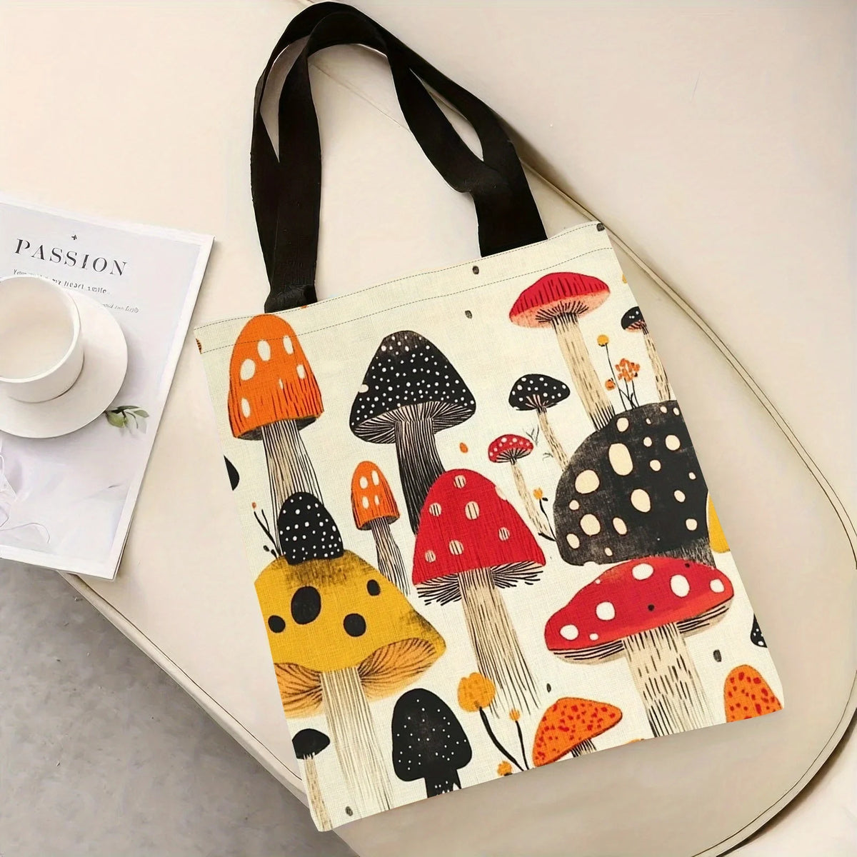 A tote bag featuring a print of various colorful mushrooms on a light background.