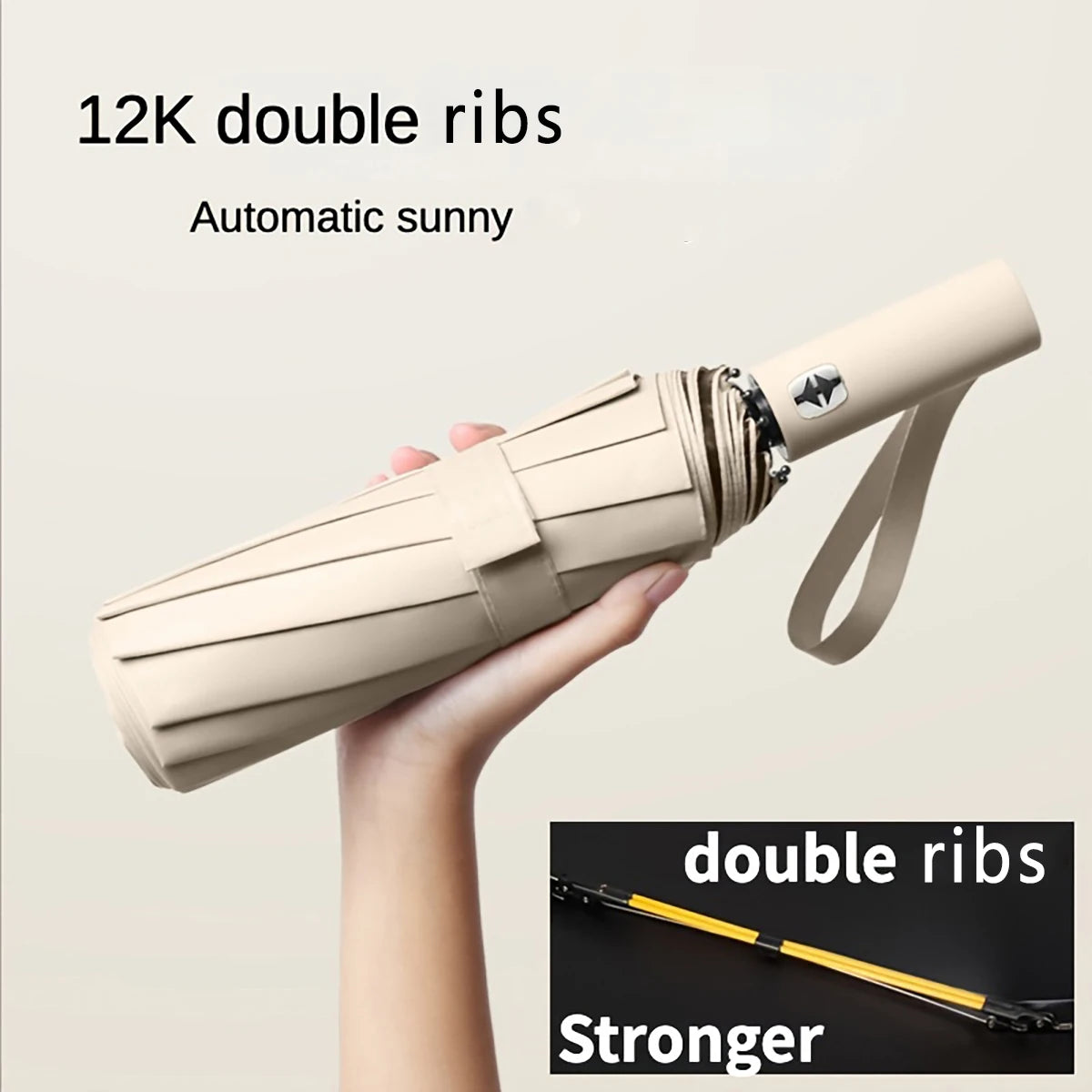 A hand holds a beige double ribs umbrella, demonstrating its compact folding design.