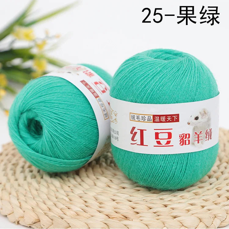 A ball of bright turquoise yarn labeled as 25-strand yarn for knitting and crochet