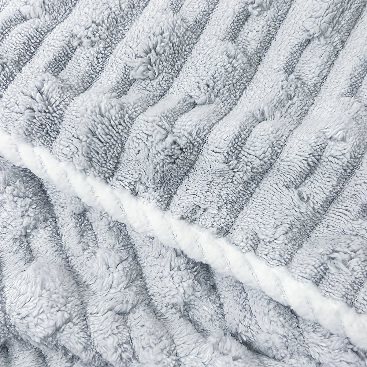 Close-up of a gray coral velvet bath towel with vertical ribbed texture.