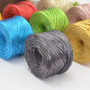 A collection of metallic flat ribbon yarn in various colors including red, green, blue, and gold, displayed in skeins.