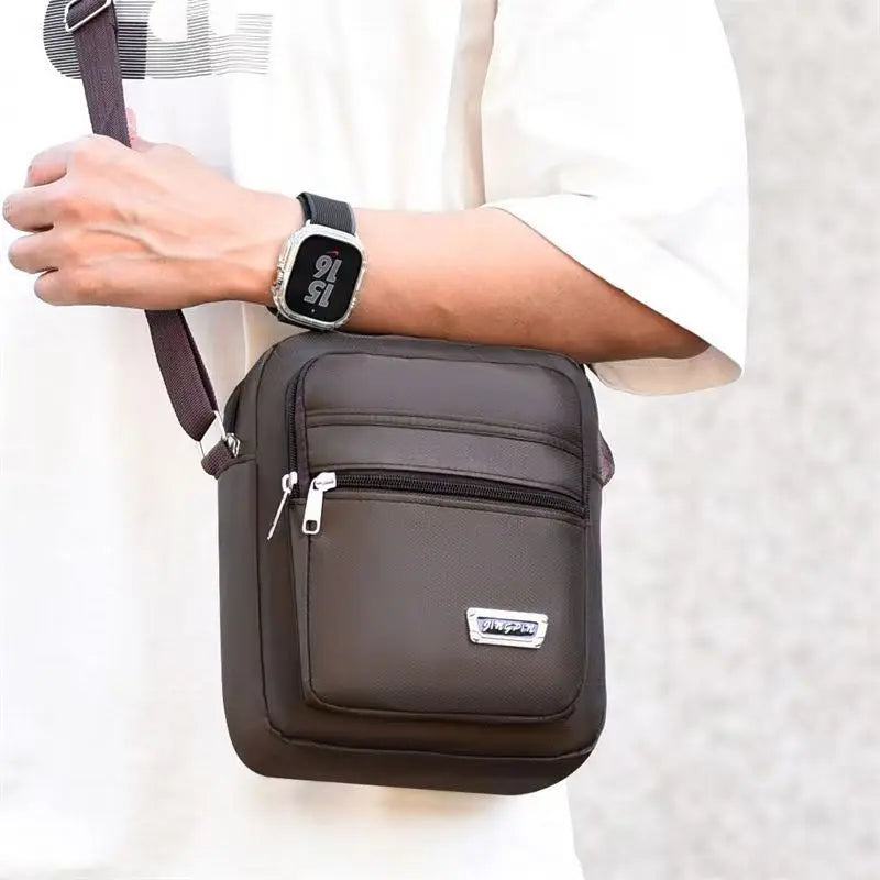 A brown water-resistant multi-pocket crossbody chest bag worn by a person.