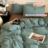 A set of striped teal and white bedding includes a duvet cover, pillowcases, and a duvet cover without a comforter.