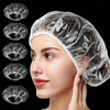 A woman is wearing a clear disposable shower cap for hair protection and salon use.