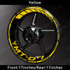 Yellow reflective decals on a black motorcycle wheel rim for a Yamaha MT-07