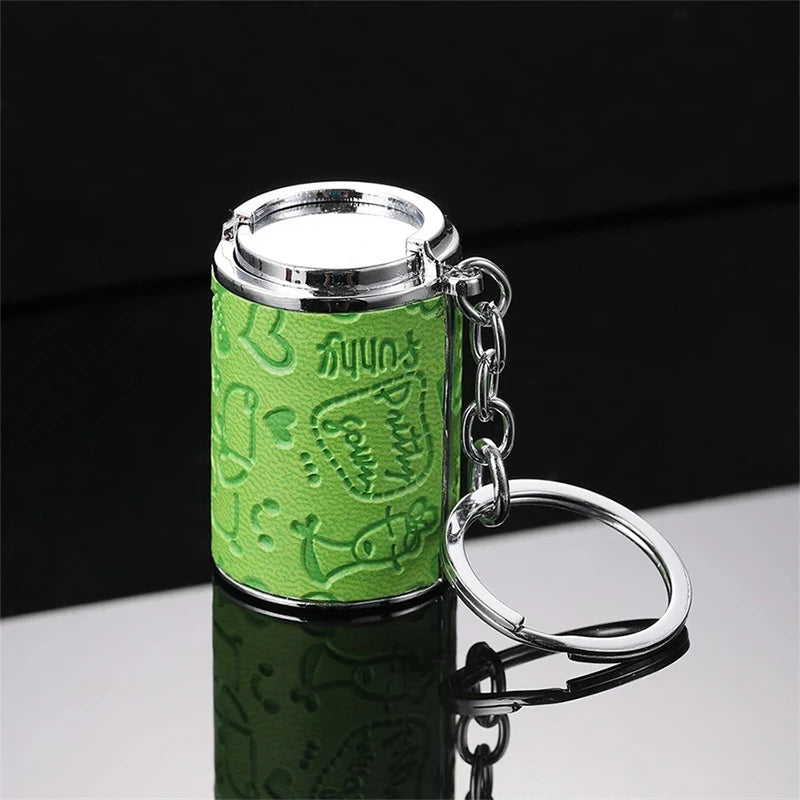 A silver metal coin tube keychain with a lime green textured wrap and a silver keyring.